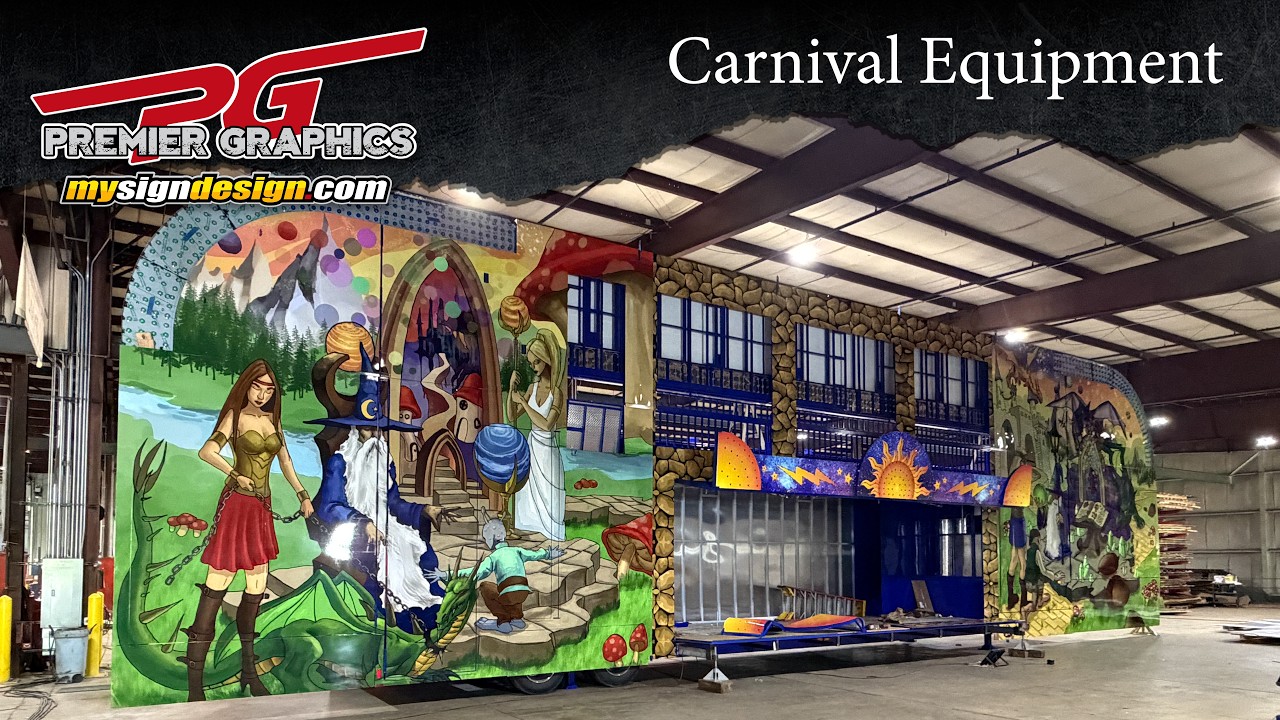 Large illustrated fantasy graphics installed across the panels of a carnival attraction.
