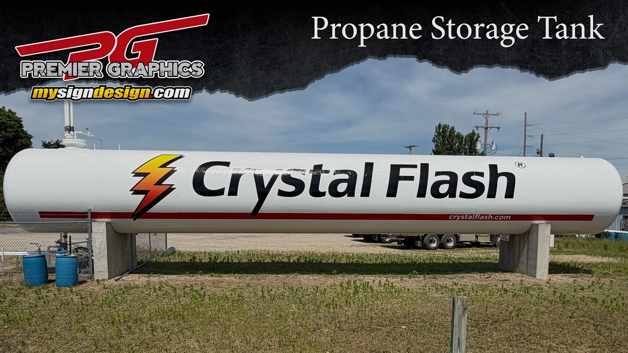 Crystal Flash branding installed across a large white propane storage tank.