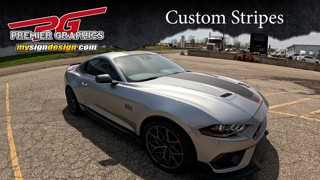 Silver Mustang Mach 1 with dark custom hood stripes and red accent outlines.